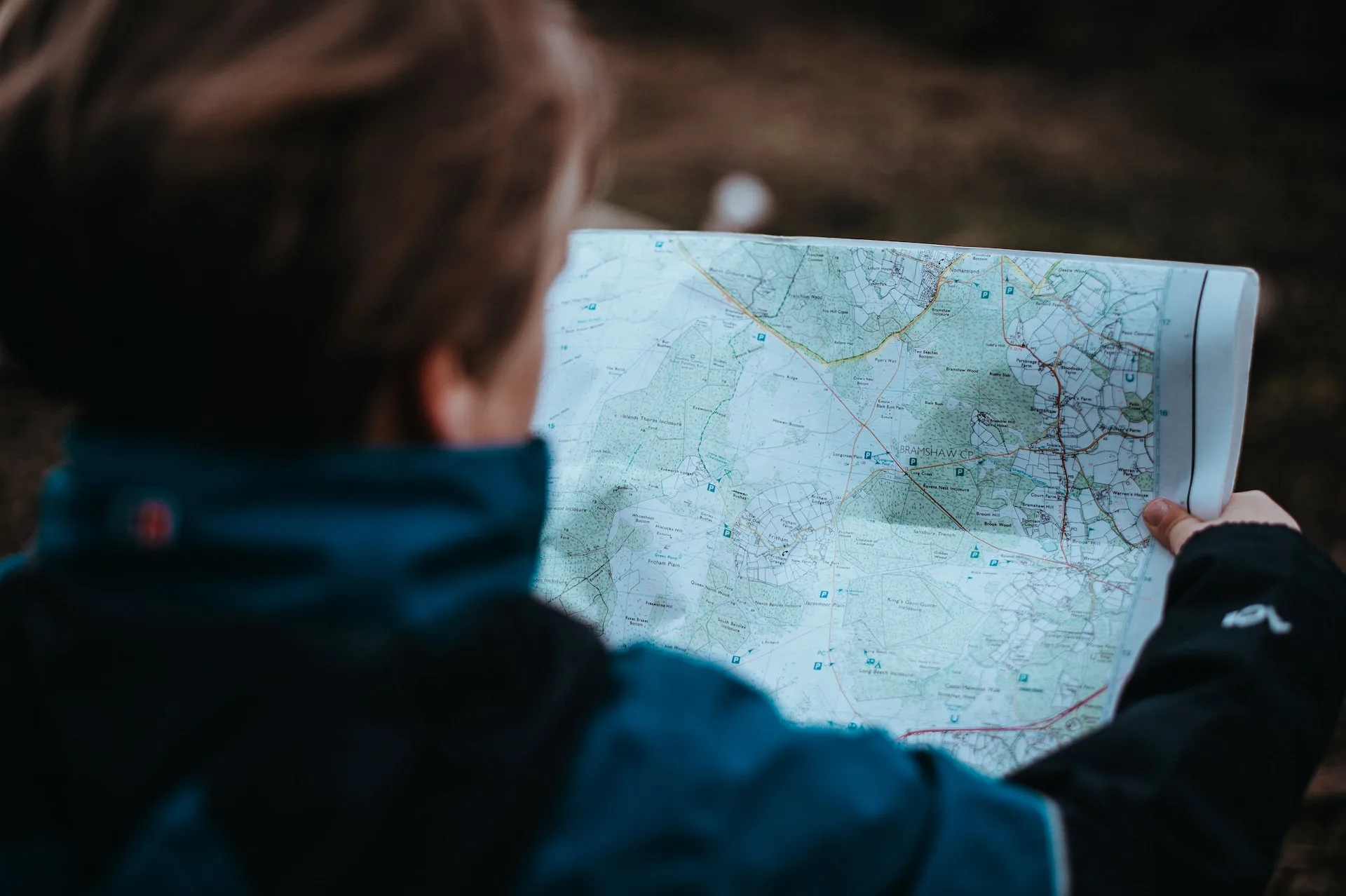 woman looking at map while hiking